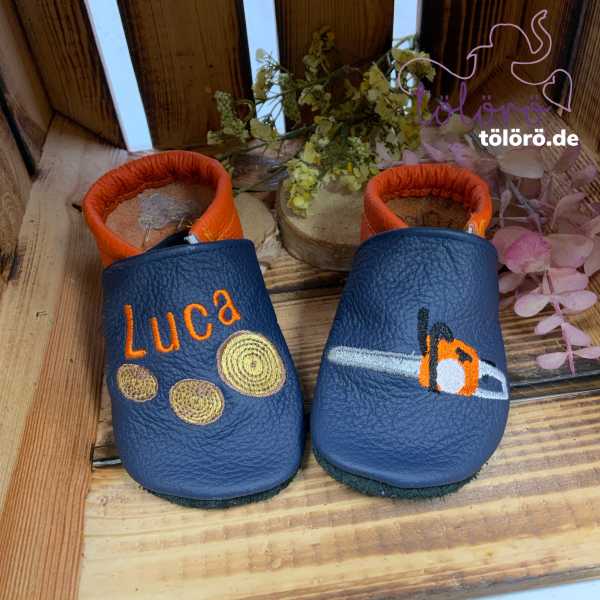 Name mit Holzscheiben und Motorsäge